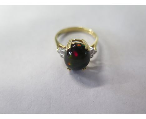 An 18ct yellow gold black opal and diamond ring, size P, approx 4.4 grams, opal approx 12mm x 10mm - in good clean condition 