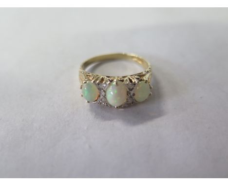 A 9ct yellow gold three stone opal and diamond ring, size S, approx 3 grams, in good clean condition 