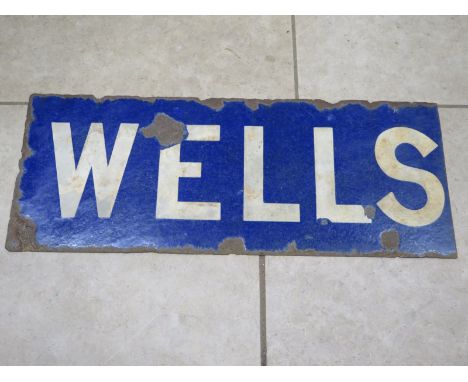 An enamel railway station sign - Wells - Norfolk - approx 37.5cm x 95cm, some rust 