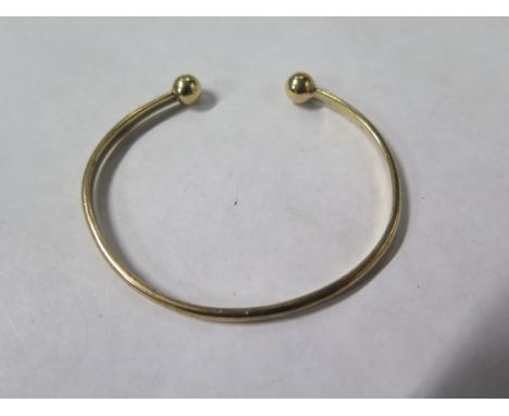 A 9ct yellow gold bangle, 6cm wide, approx 8.5 grams, minor usage 