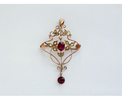 A Belle Epoque yellow-metal, garnet and seed pearl openwork pendant brooch, in a whiplash arrangement, centrally set with an 