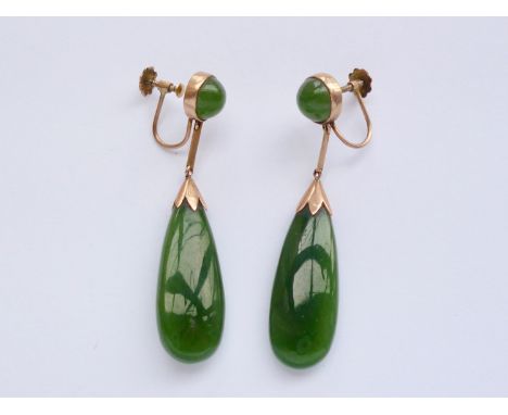 A vintage pair of yellow-metal and jade ear pendants, having a spherical cabochon stud above a slender polished drop, with sc