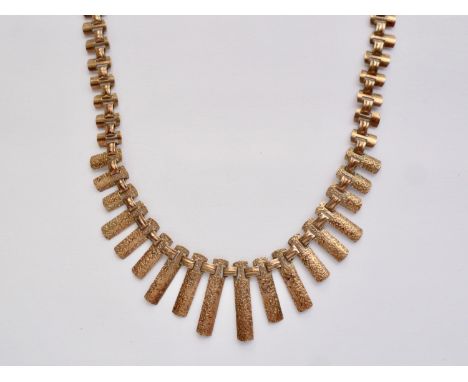 A vintage 9ct gold fringe necklace, having graded bark-effect and polished rectangular links interlaced by spacers, stamped 9