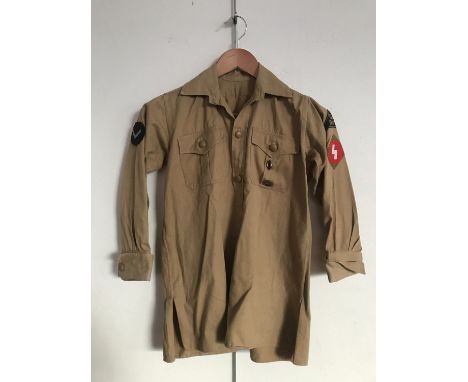 A Hitler Youth service shirt bearing Nord Nordsee district badge, Oberbann 1 and DJ-Hordenfuhrer rank patches, Deutsche Arbei