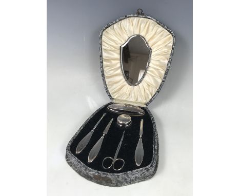 A 1920s cased silver mounted manicure set, having engine-turned banded decoration, James Deakin and Sons, Chester, 1929