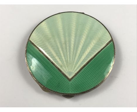 A 1920s lady's Art Deco guilloche engraved and parcel-gilt silver powder compact, of circular section, the cover having a geo