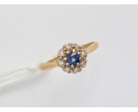 A vintage sapphire and diamond dress ring, pellet-set in a flower head cluster arrangement on an 18ct gold cathedral shank wi