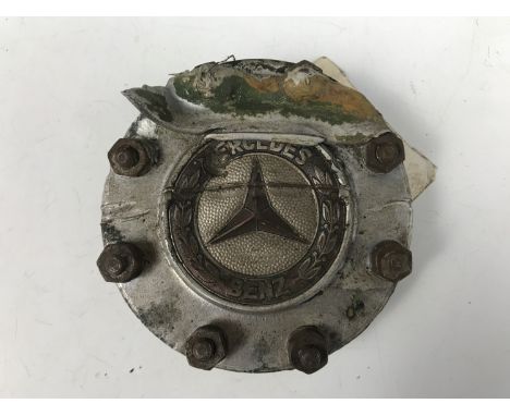 A Luftwaffe Mercedes Benz aircraft engine badge bearing a label which reads Me 110 Ashdown Forest cricket pitch site