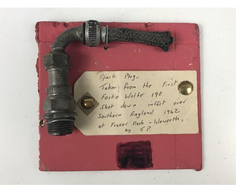 A Luftwaffe aircraft engine spark plug bearing label which reads "taken from the first Focke Wolfe 190 shot down intact over 