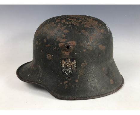 An Imperial German German steel helmet bearing German Third Reich Army decal and M 35 liner