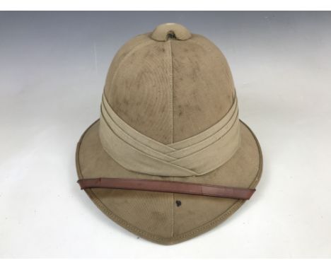 A 1941 British Army Wolseley pattern tropical helmet and cover, each bearing the details of their original owner, 821524 Gunn