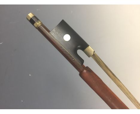 A violin bow bearing the maker's name V J Ferelli, having nickel mounts and a mother of pearl inlaid ebony frog (a/f one butt