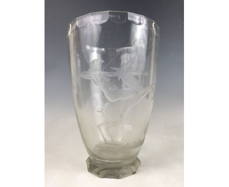 An Art Deco engraved glass vase in the style of Orrefors, of ovoid form and raised over a faceted foot, decorated with a figu