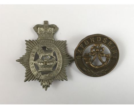 A Victorian militia badge and Oxfordshire Light Infantry helmet plate centre