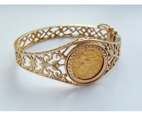 A 1912 gold half sovereign set to the face of a reticulated and hinged yellow-metal bangle, 21.9g total 