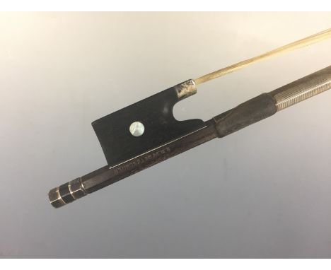 A violin bow by Hermann Richard Pfretzschner (1857-1921), having a white-metal mounted ebony frog with mother-of-pearl button