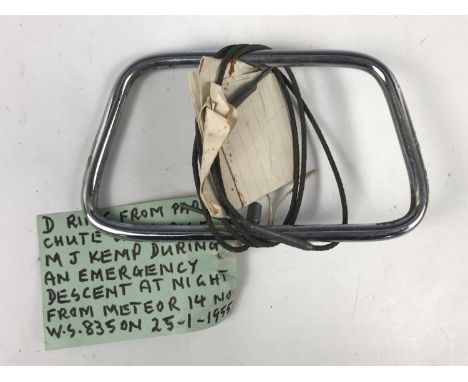 An RAF parachute pull ring bearing a label which reads "D ring from parachute used by F-O M J Kemp during an emergency descen