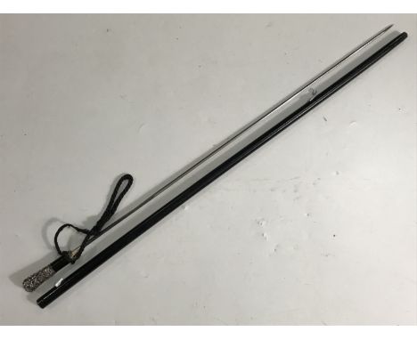 A late 19th Century ebonised sword stick, the chased and engraved white-metal pommel stamped 'Metal Argente' 