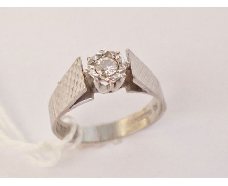 A vintage 18ct white gold diamond solitaire ring, the brilliant-cut diamond of approximately .10ct illusion-set to the centre