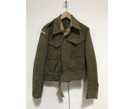 A Second World War Serge Battledress blouse bearing Home Guard shoulder titles, (lacking label)