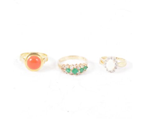 Three gemset dress rings, a round cabochon cut coral collet set in a yellow metal mount marked 750, ring size S, an opal and 