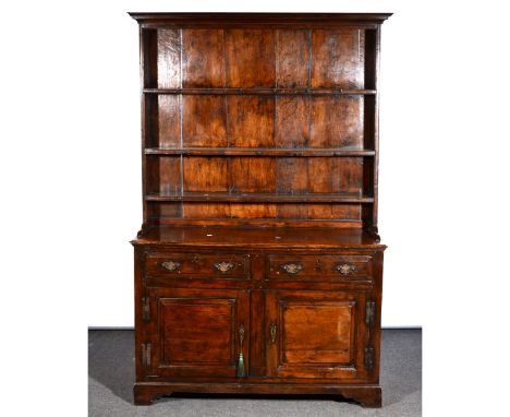 Joined oak dresser, cavetto moulded cornice, panelled back with three fixed shelves, the base with a rectangular top, moulded