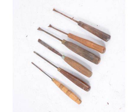 Large collection of woodworking hand tools, including block planes, chisels, files, and carving tools.