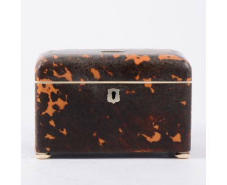 A tortoiseshell twin compartment tea caddy, rectangular, 18cm x 10cm x 3cm high, internal ivory frame to top and base, button