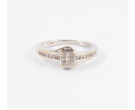 A contemporary diamond cluster ring, nine princess cut diamonds set as a square cluster with seven diamonds channel set into 