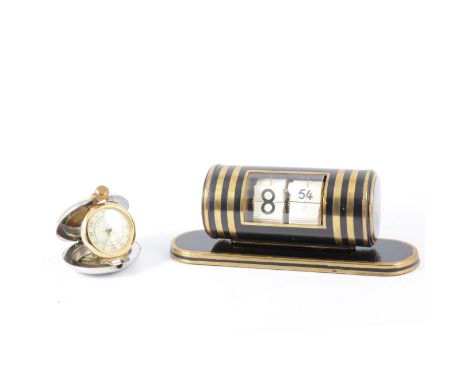 A vintage German Abessi desk top flip clock, black barrel with brass bands, winds and changes time from one end of the barrel