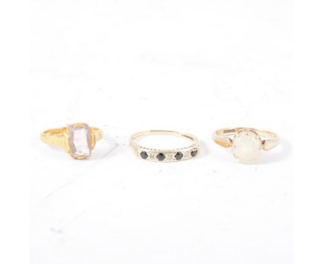 Three gem set dress rings, an oval cabochon cut opal in a solitaire mount marked 9ct, ring size R, a pale amethyst coloured f