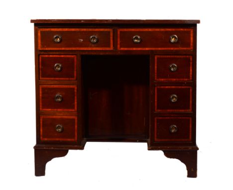 George mahogany kneehole desk, rectangular top with leather inset (defective), kneehole with a cupboard, surrounded by eight 