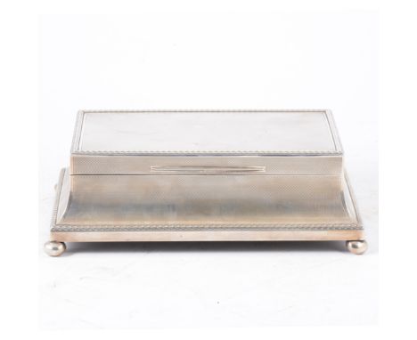 An impressive Asprey &amp; Co. cigarette/jewel casket, engine turned design with leaf border, concave sides, all supported on