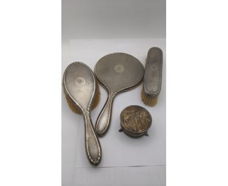 Silver dressing table items to include engine turned hand mirror, hand brush and one other brush together with a ring box on 