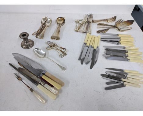 A collection of mixed silver plated flatware to include butter knives, serving spoons and others, along with a hallmarked sil