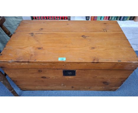 A small stained pine travel trunk having wrought iron side handles. Location:RWMIf there is no condition report, please reque