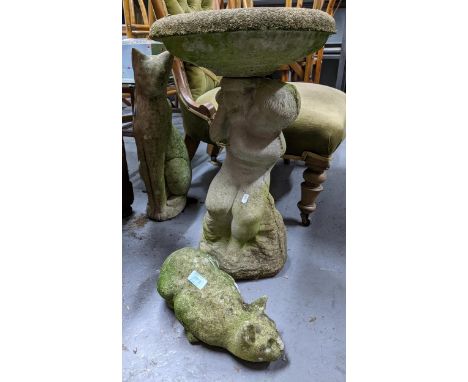 A group of garden weathered concrete ornaments to include a bird bath having circular top supported by a figural putti seated