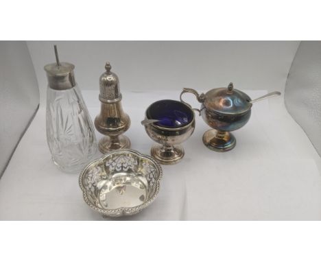 Silverware to include a three piece condiment set, a pedestal mustard pot, a salt and pepper pot with blue glass liners hallm