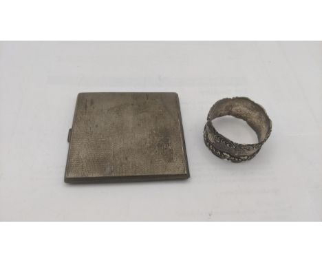 A silver engine turned cigarette case, hallmarked Birmingham 1933, having a guilt interior, along with a silver napkin ring. 