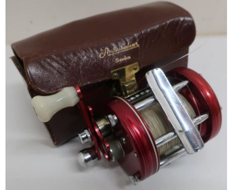 Abu Ambassadeur multiplier 6000 fishing reel, red anodized finish, with instructions, oil, additional screws, spanner etc in 