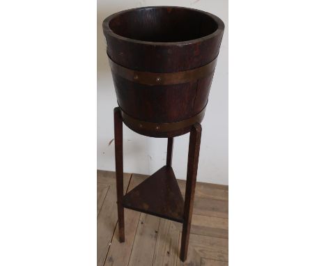 R. A. Lister &amp; Co Ltd copper bound coopered oak jardinière, square tapered supports joined by triangle stretcher (92cm x 