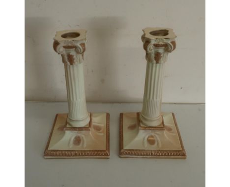 Pair of Victorian Royal Worcester candlesticks, with stop fluted columns and acanthus scroll capitals, on square bases, impre