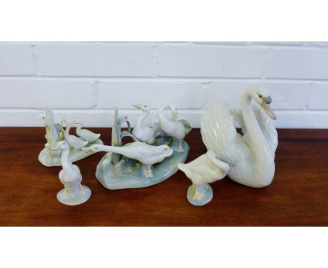 A set of three Lladro Geese figures, a Nao group of Geese and a Lladro figure of a Swan, (5)