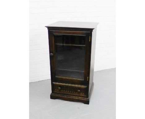 An Ercol dark elm music cabinet with glazed door to front 98 x 56cm 