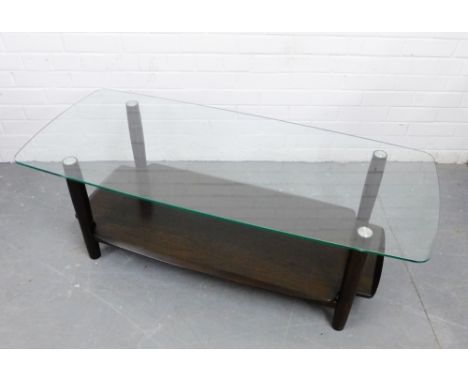 An Ercol glass topped coffee table on dark elm turned supports and undertier, 44 x 130cm 