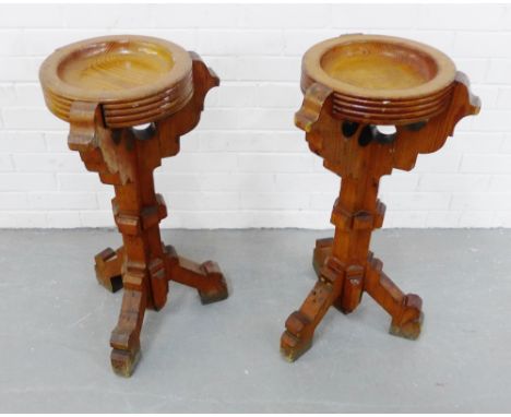 A pair of light oak church collection bowls on carved tripod supports, 77cm high (2) 