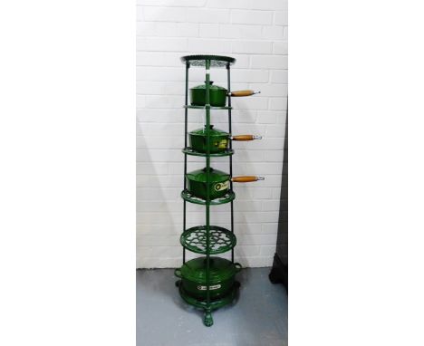 A set of four green enamel le creuset cooking pots, together with a six tier green metal stand (5) 