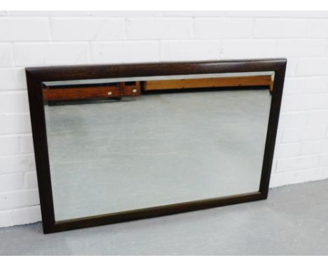 An Ercol dark elm rectangular framed wall mirror, 63 x 94cm