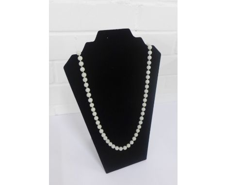 A strand of pale green jade beads, with a silver clasp