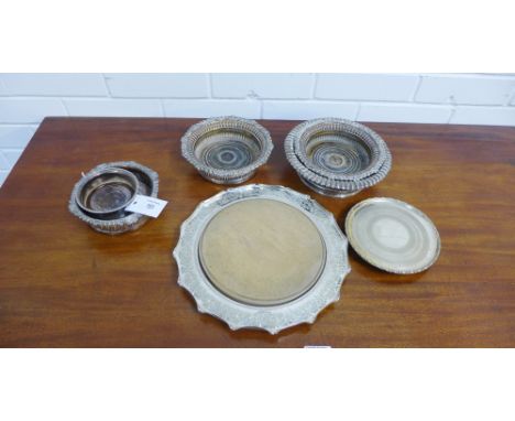 A collection of five various Epns and Old Sheffield plate wine coasters, together with a small carved Epns card tray and an E